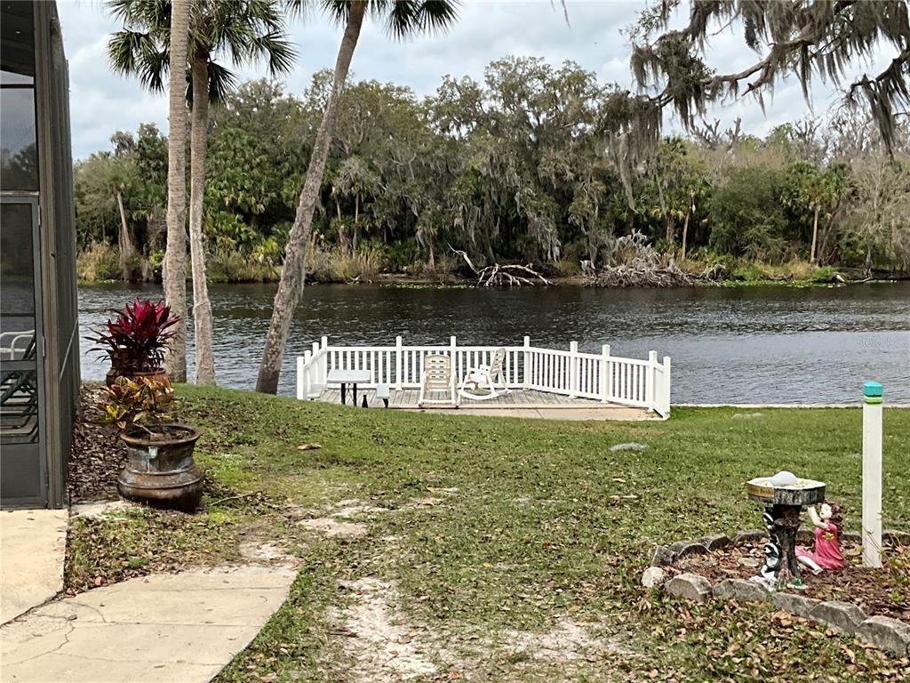 116 Traders Cove Boulevard DeBary, FL 32713 - Photo 52 of 60 a backyard of a house with lots of green space and lake view