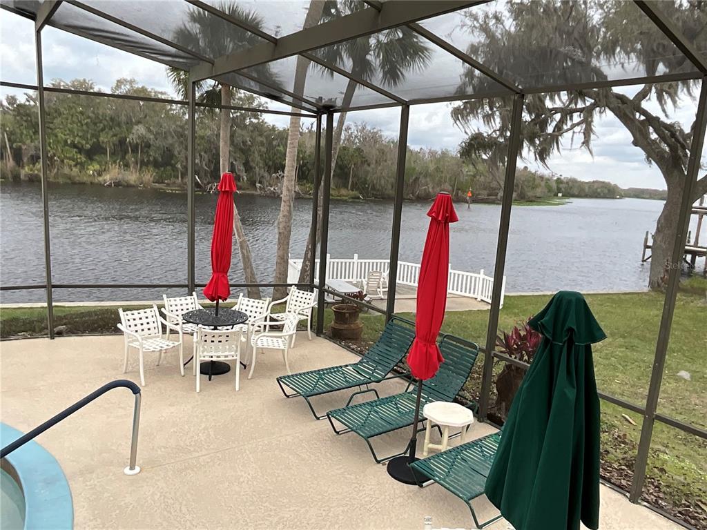 116 Traders Cove Boulevard DeBary, FL 32713 - Photo 60 of 60 a view of roof deck with a dining table and chairs under an umbrella