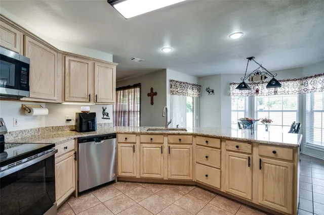 a kitchen with white cabinets sink and appliances