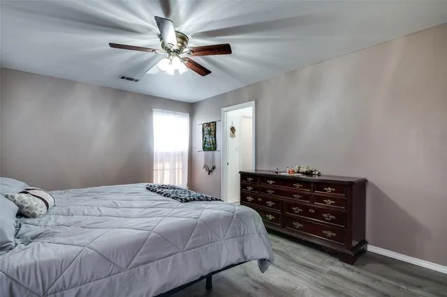 a bedroom with a bed dresser and a window