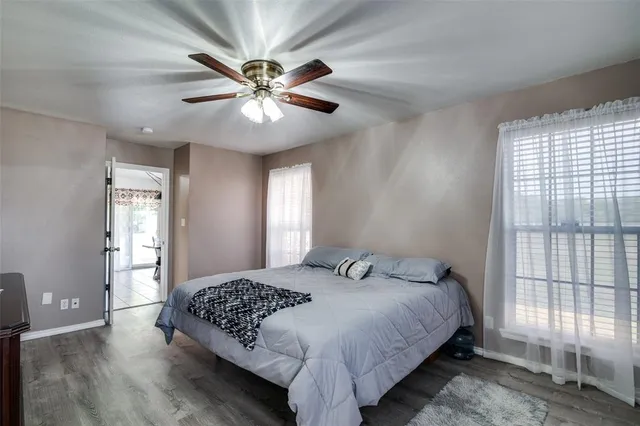 a bedroom with a large bed and a chandelier