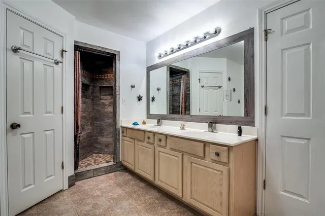a bathroom with a double vanity sink and a mirror