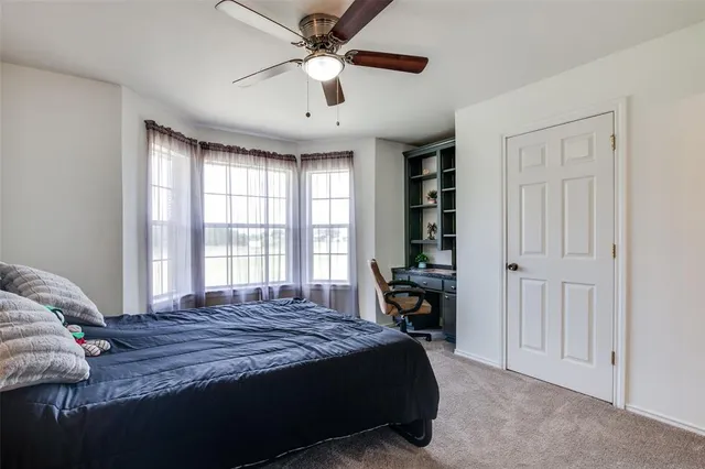 a bedroom with a large bed and a chandelier