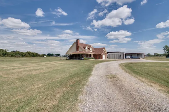 a view of a houses with swimming pool and mountains in the background