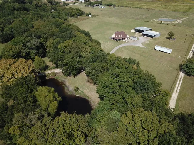 an aerial view of a house with a yard