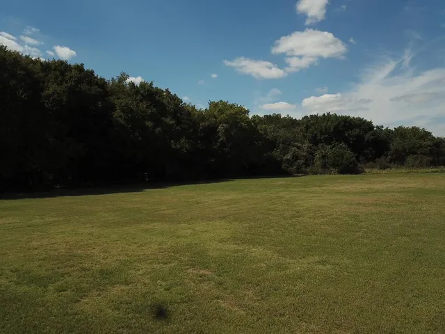 a view of lake with a yard