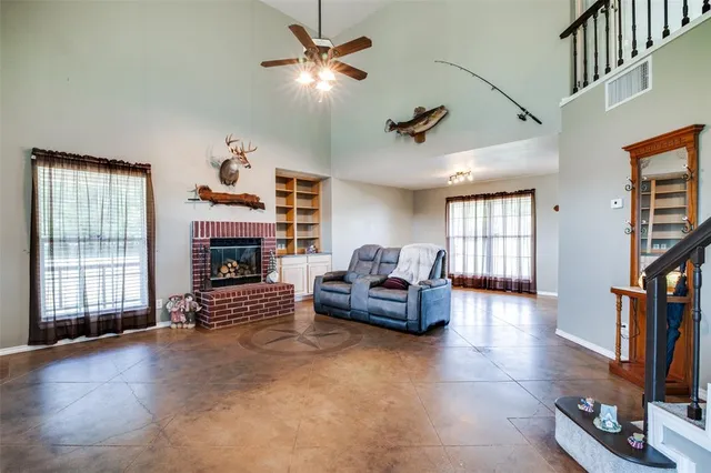 a living room with fireplace furniture and a window