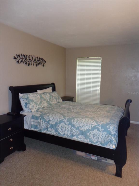 1120 Southwest 19th Place Gainesville, FL 32601 - Photo 11 of 30 a bedroom with a bed and window
