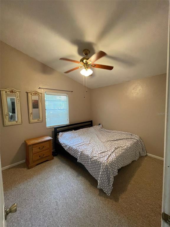 1120 Southwest 19th Place Gainesville, FL 32601 - Photo 23 of 30 a bed sitting in a bedroom next to a window