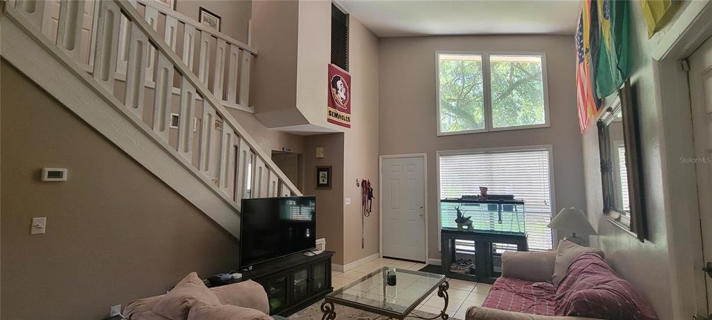 1120 Southwest 19th Place Gainesville, FL 32601 - Photo 7 of 30 a living room with furniture windows and a flat screen tv