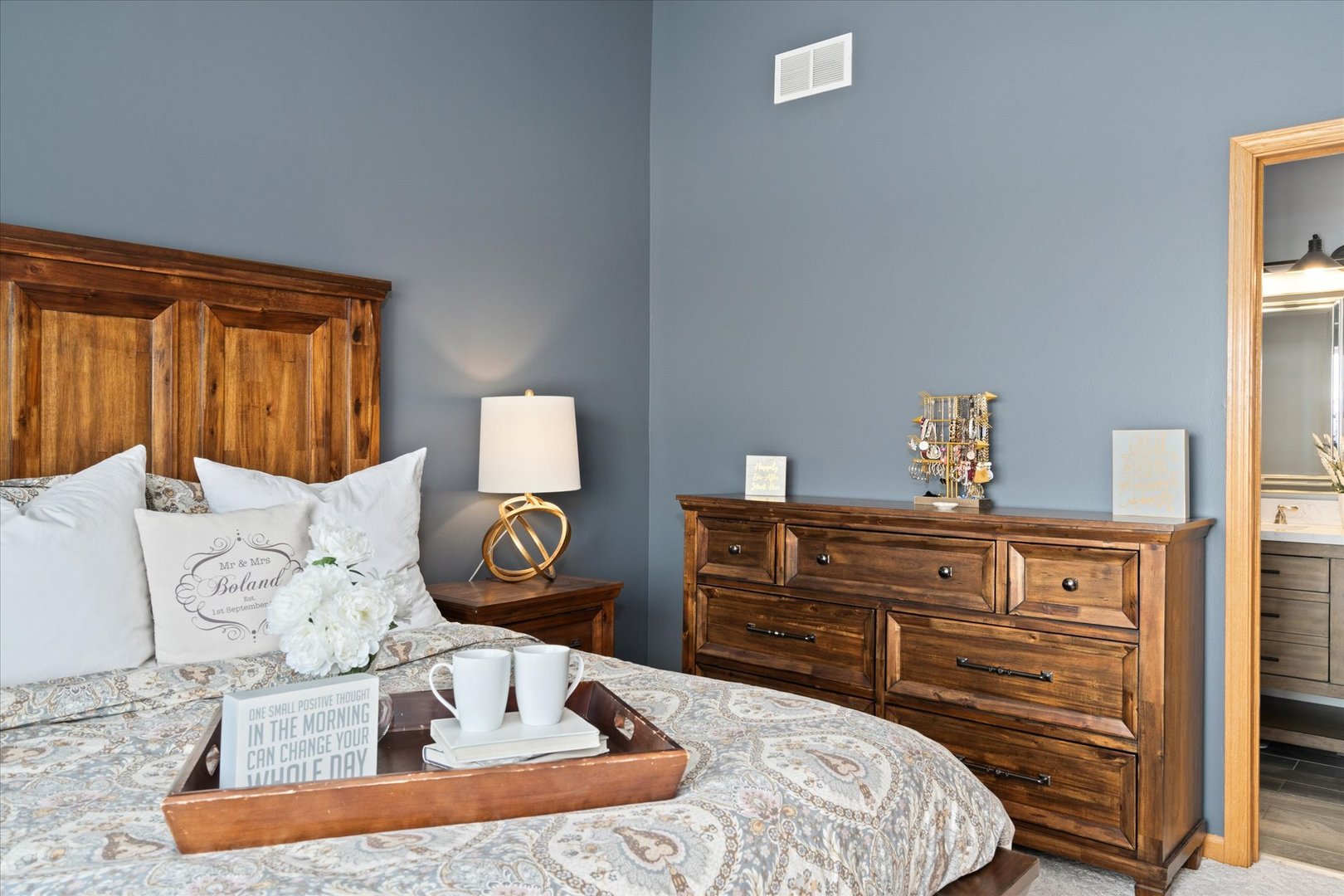 2609 Carrolwood Road, Unit 2609 Naperville, IL 60540 - Photo 11 of 17 a bedroom with a bed and dresser with mirror