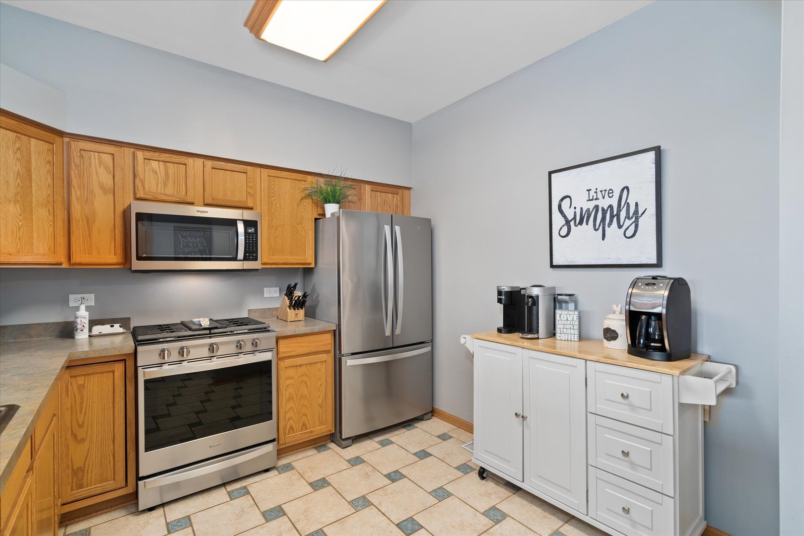 2609 Carrolwood Road, Unit 2609 Naperville, IL 60540 - Photo 2 of 17 a kitchen with white cabinets and stainless steel appliances
