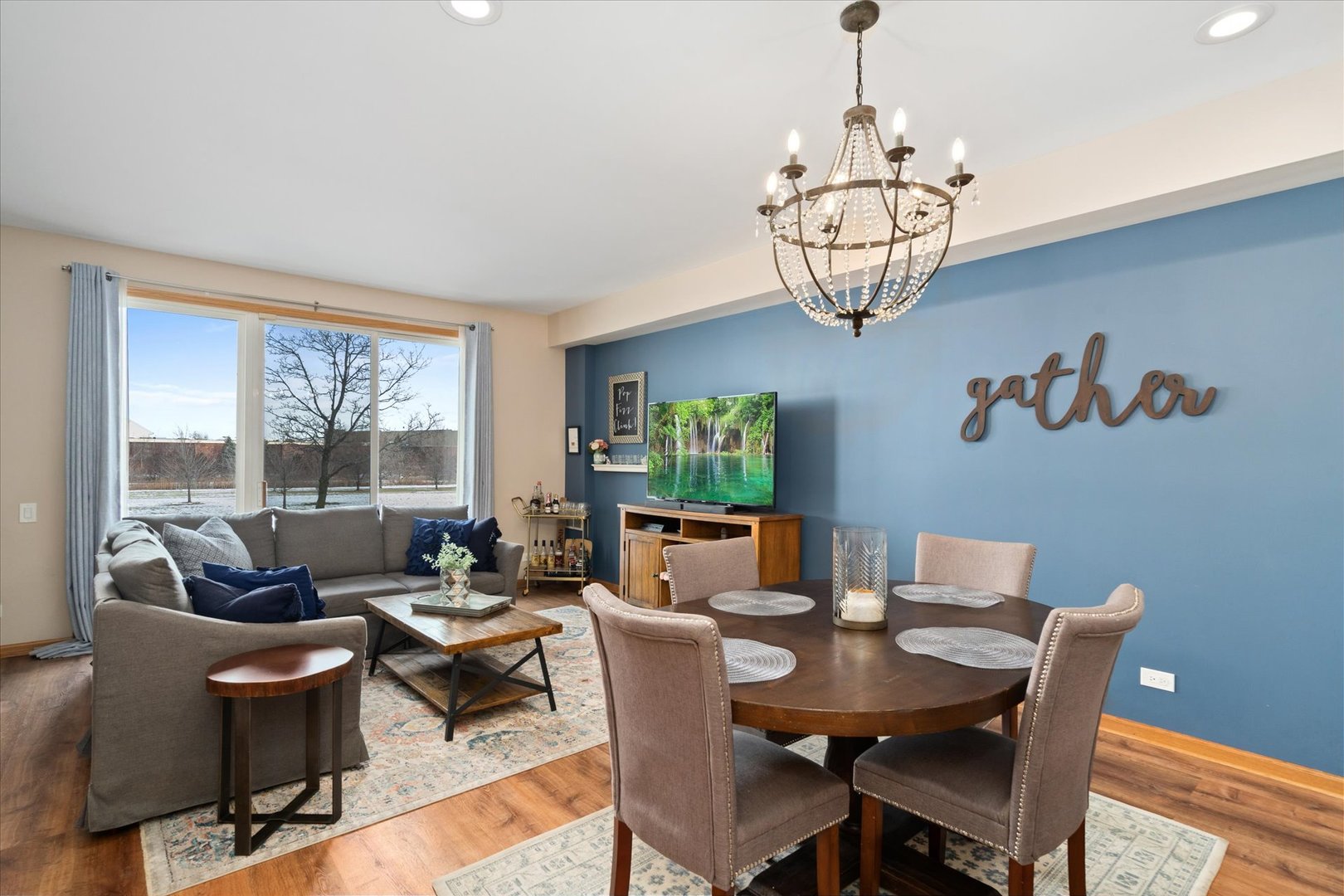 2609 Carrolwood Road, Unit 2609 Naperville, IL 60540 - Photo 5 of 17 a dining room with furniture a chandelier and window
