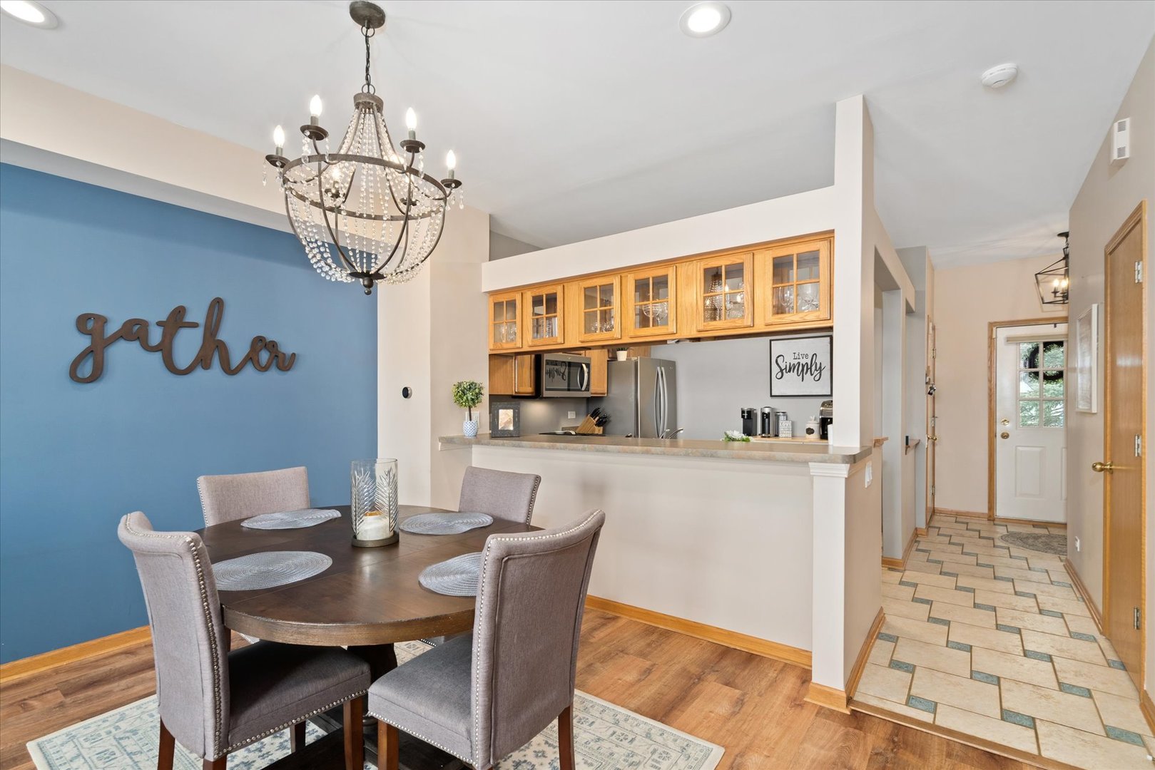 2609 Carrolwood Road, Unit 2609 Naperville, IL 60540 - Photo 6 of 17 a view of a dining room with furniture wooden floor and chandelier