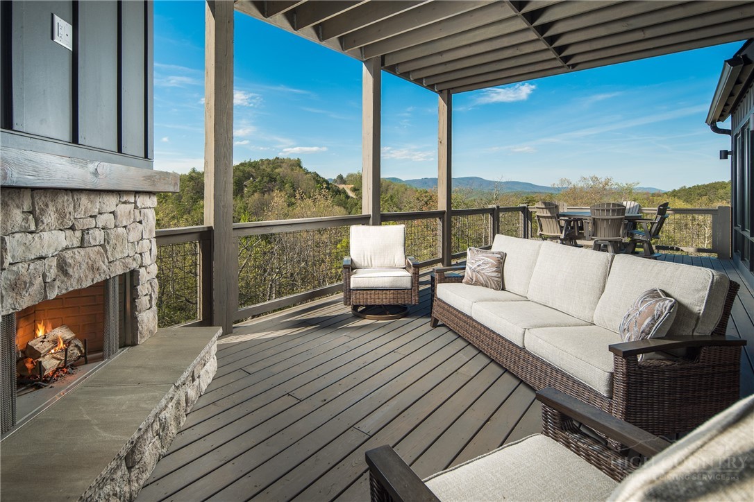 359 Calico Court Boone, NC 28607 - Photo 9 of 50 a balcony with furniture and a fireplace
