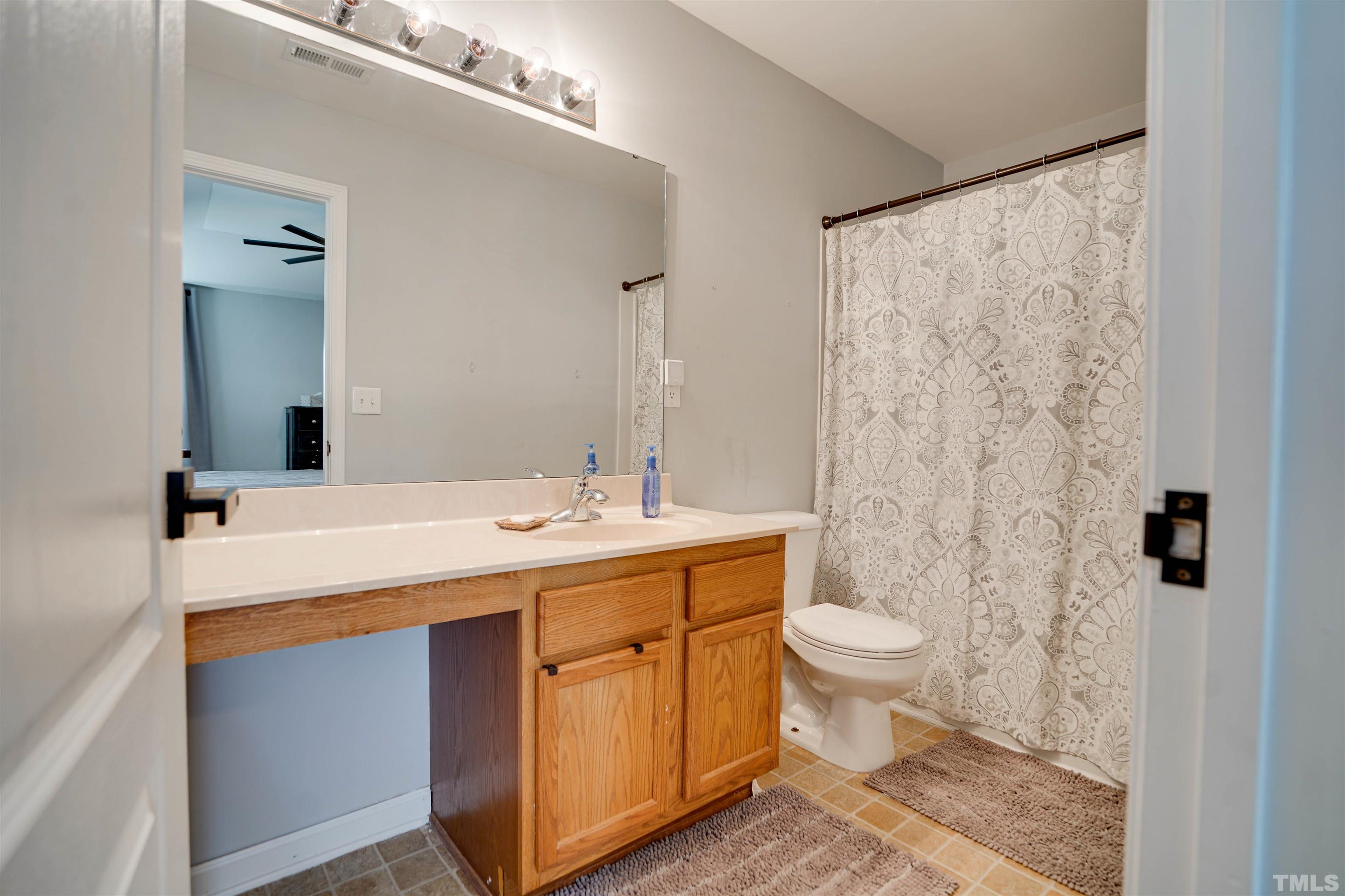 3626 Willano Way Raleigh, NC 27610 - Photo 14 of 20 a bathroom with a sink toilet and shower