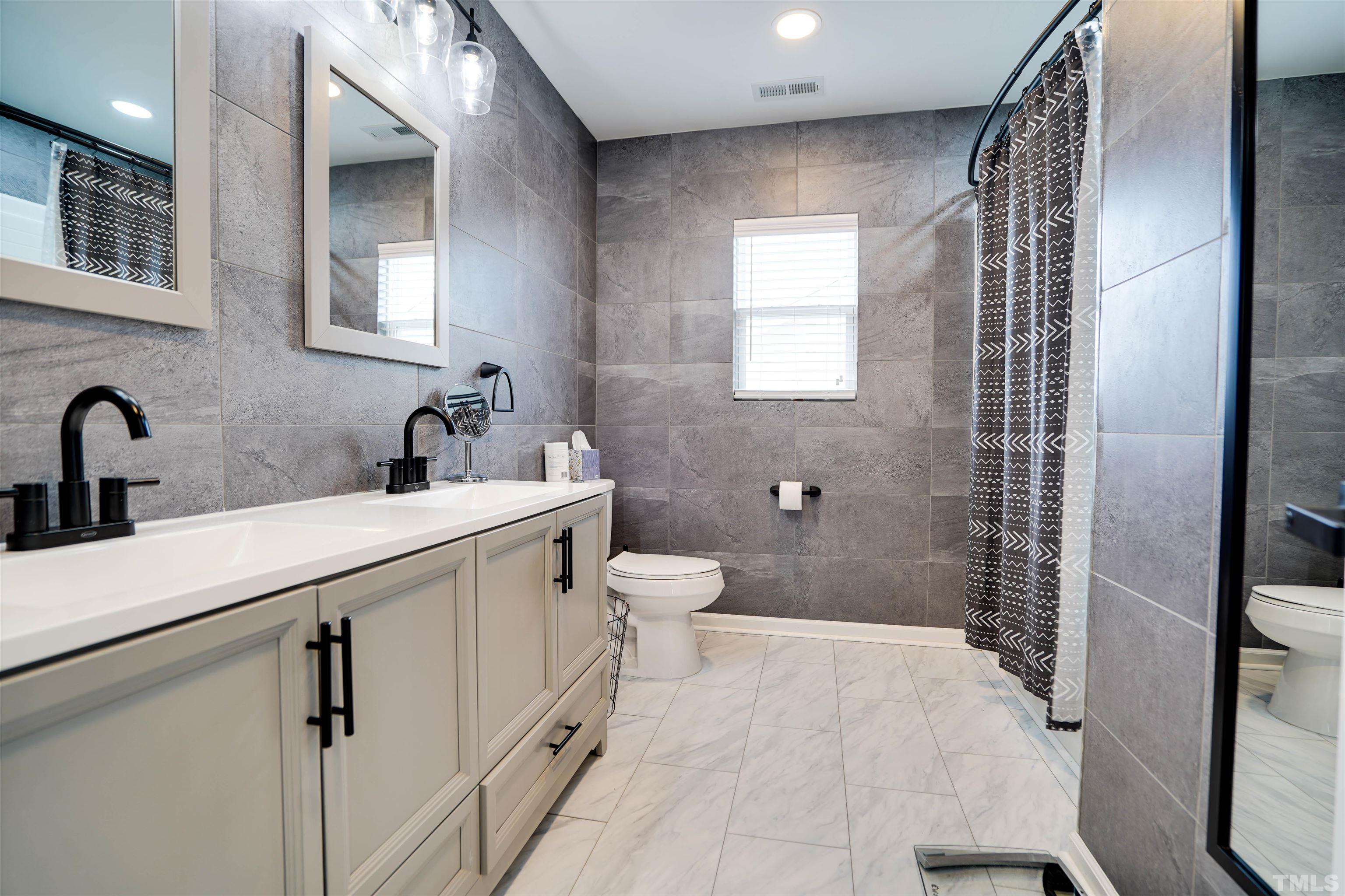 3626 Willano Way Raleigh, NC 27610 - Photo 16 of 20 a bathroom with a sink a toilet and shower