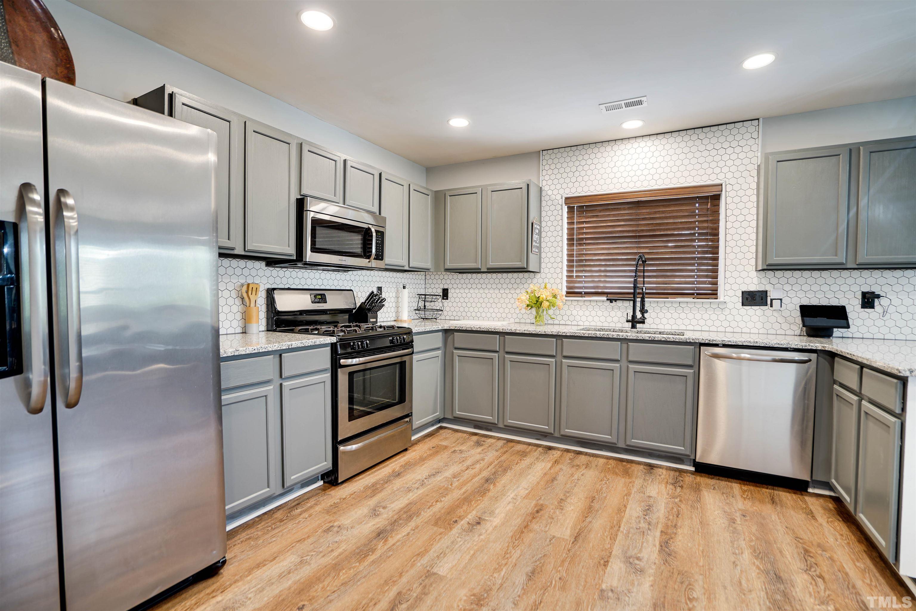 3626 Willano Way Raleigh, NC 27610 - Photo 8 of 20 a kitchen with stainless steel appliances a refrigerator sink and microwave