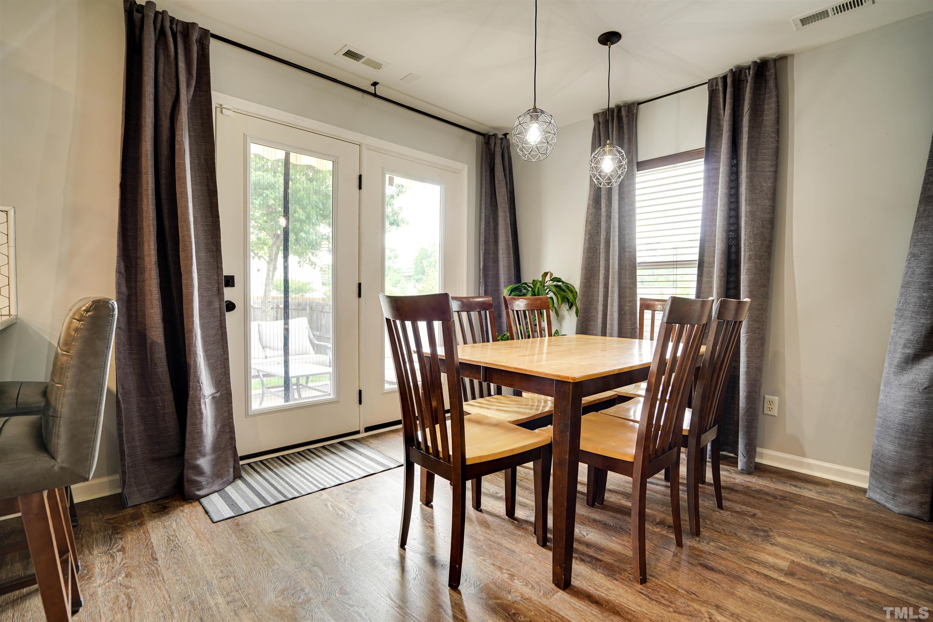 3626 Willano Way Raleigh, NC 27610 - Photo 10 of 20 a view of a dining room with furniture window and wooden floor