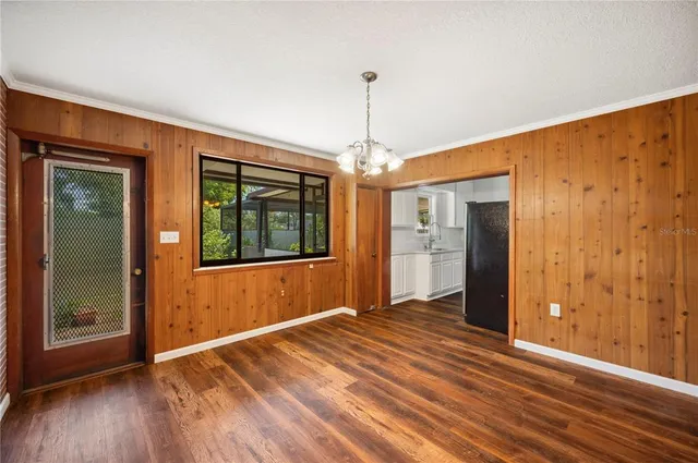 a view of a livingroom with wooden floor and chandelier