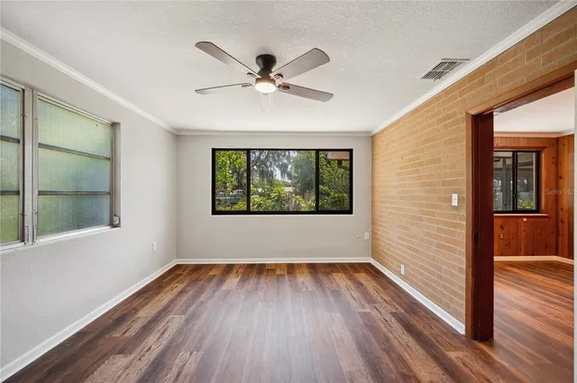 a view of empty room with wooden floor