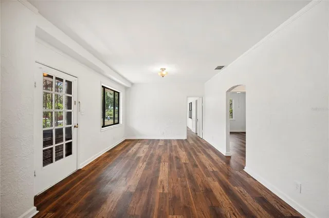 a view of a room with wooden floor and windows