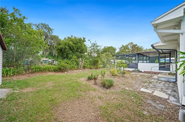 a view of a house with backyard porch and furniture