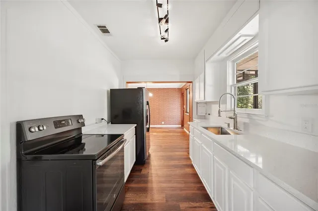 a kitchen with a refrigerator and a sink