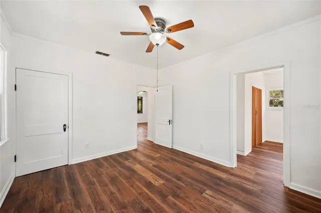 a view of an empty room and wooden floor