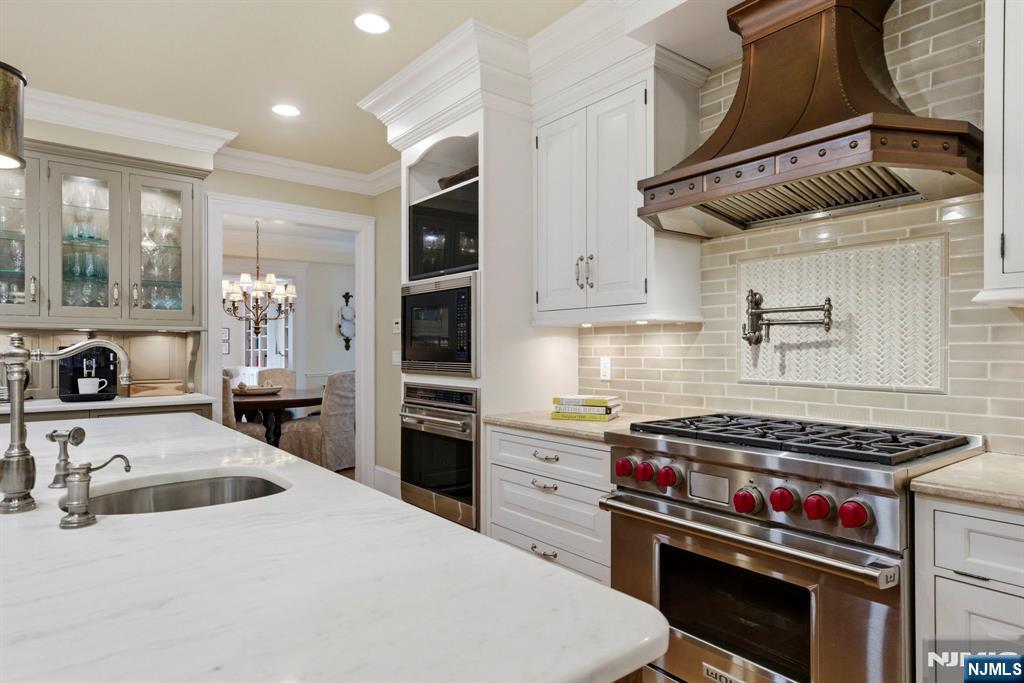 203 Heights Road Ridgewood, NJ 07450 - Photo 7 of 41 a kitchen with a stove and a sink