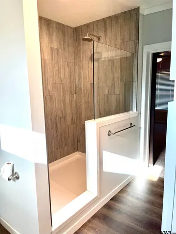 a bathroom with a shower and a tub