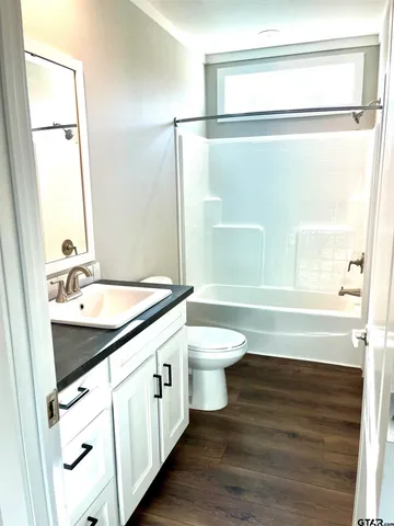 a view of walk in closet with wooden floor