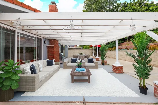 a view of the patio with couches and potted plants