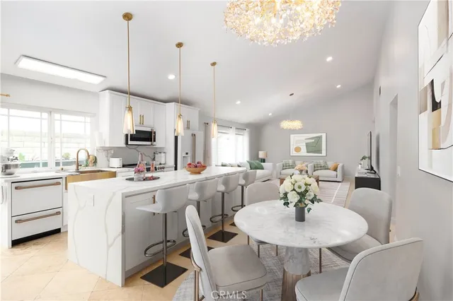 a kitchen with cabinets a sink stainless steel appliances and dining table