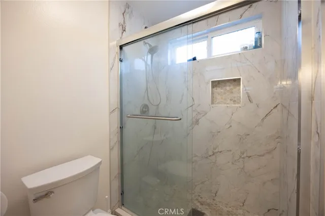 a bathroom with a shower and a toilet