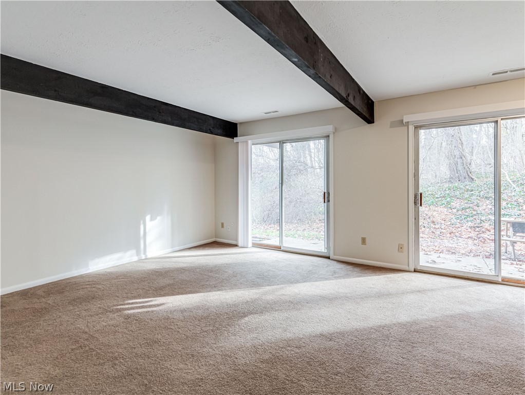 2550 Chamberlain Road, Unit A3 Akron, OH 44333 - Photo 6 of 21 Carpeted living room featuring beamed ceiling