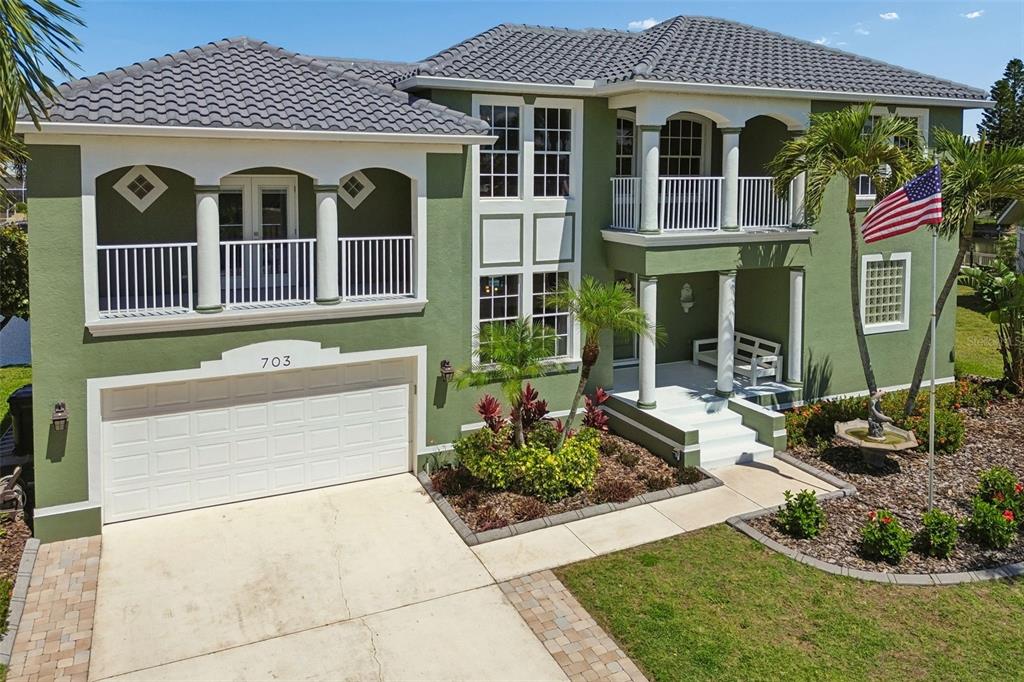 703 Bunker View Drive Apollo Beach, FL 33572 - Photo 1 of 49 a front view of a house with garden