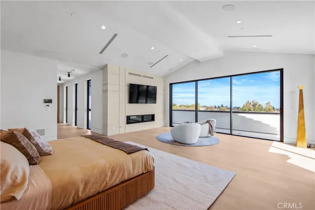 a bedroom with a large bed and a couch