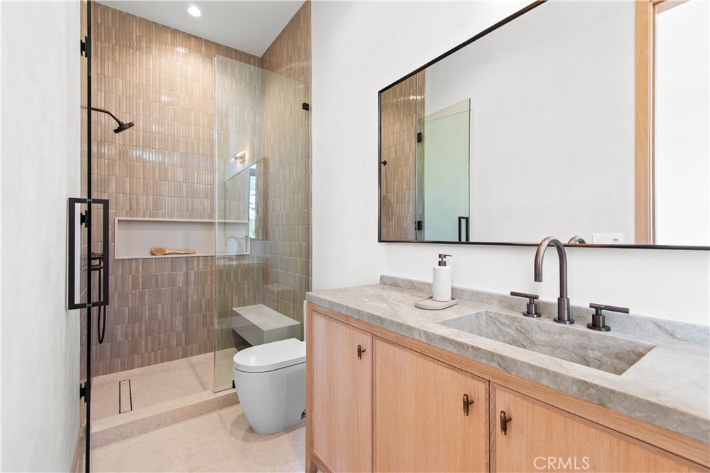 5340 Whitman Road Hidden Hills, CA 91302 - Photo 30 of 57 a bathroom with a granite countertop sink toilet and shower