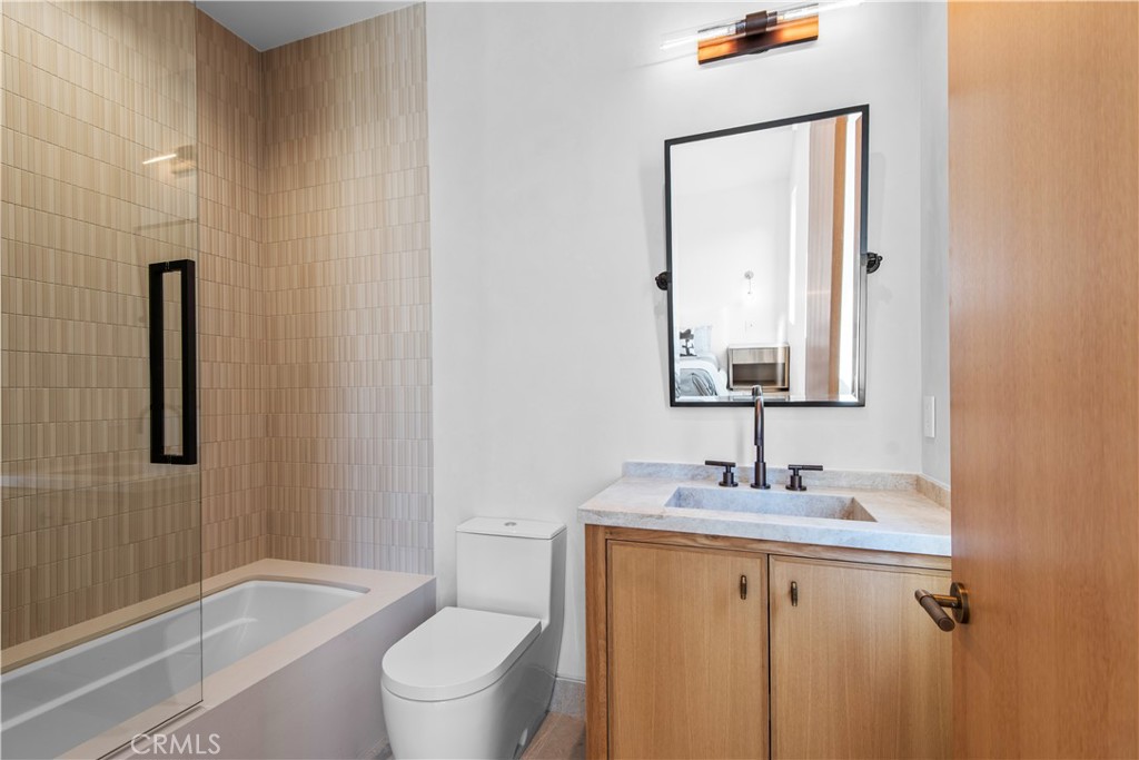 5340 Whitman Road Hidden Hills, CA 91302 - Photo 33 of 57 a bathroom with a granite countertop sink toilet and shower