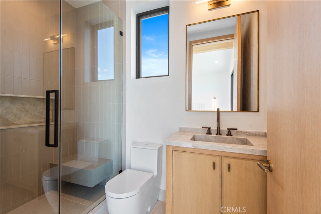 5340 Whitman Road Hidden Hills, CA 91302 - Photo 35 of 57 a bathroom with a toilet sink vanity and mirror