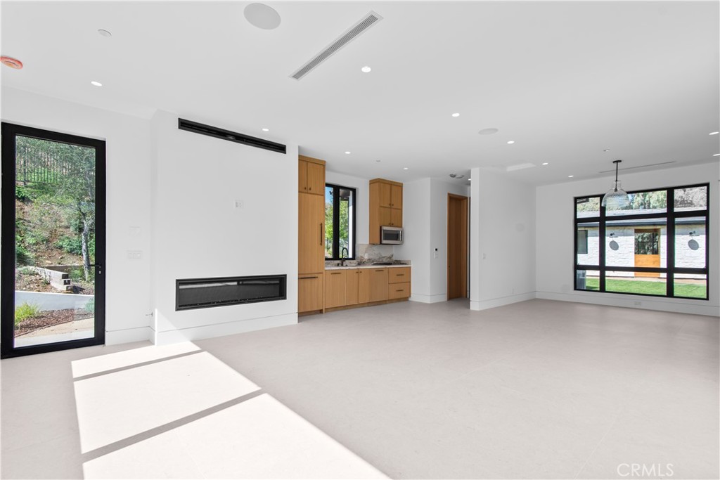 5340 Whitman Road Hidden Hills, CA 91302 - Photo 36 of 57 a view of an empty room with a window and a kitchen