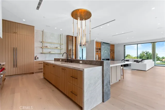 a large kitchen with stainless steel appliances granite countertop a lot of counter space and a sink