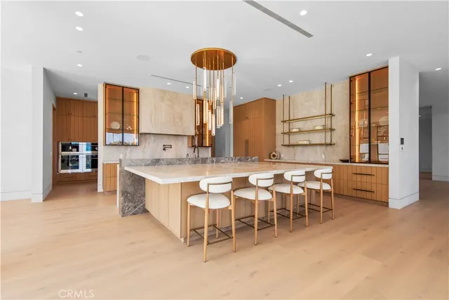 a large kitchen with granite countertop a sink and a refrigerator