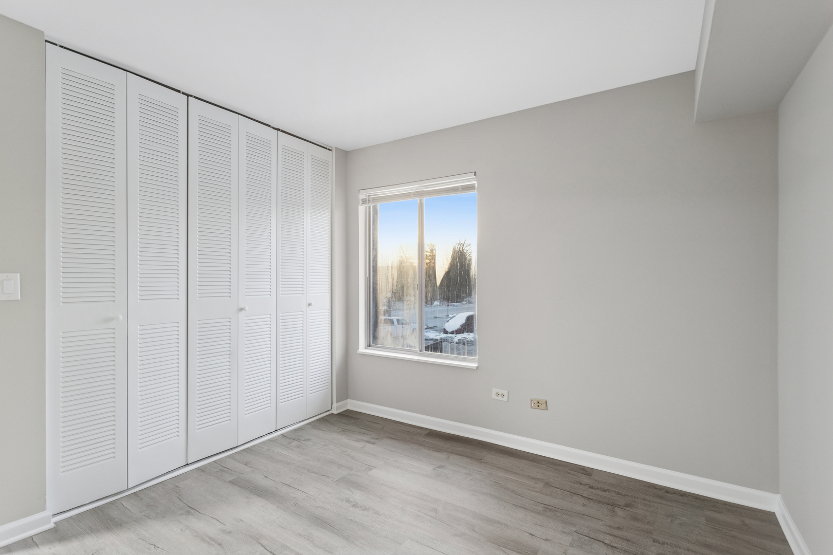 6185 Pinewood Court, Unit 202 Willowbrook, IL 60527 - Photo 11 of 20 a view of an empty room with window and wooden floor