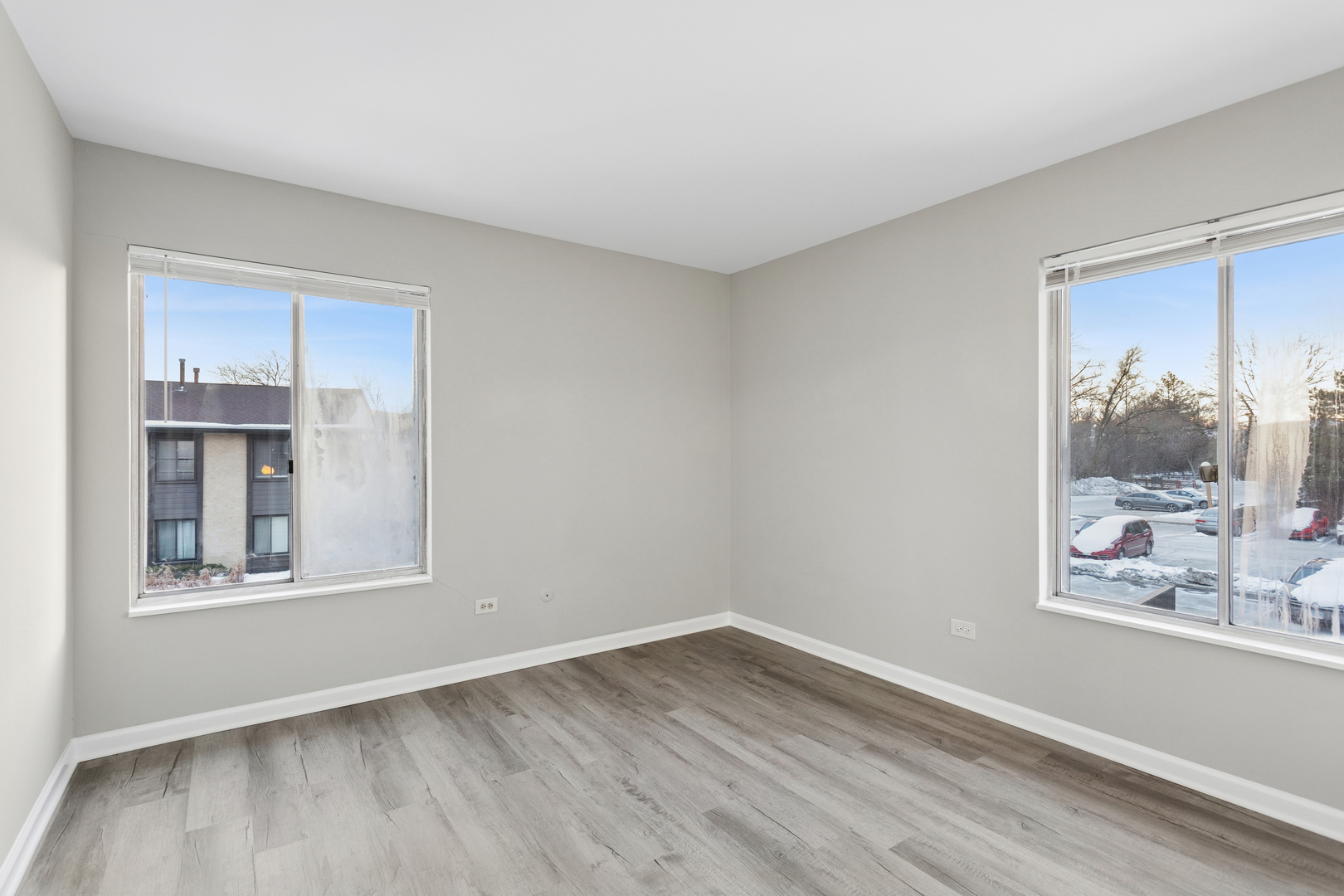 6185 Pinewood Court, Unit 202 Willowbrook, IL 60527 - Photo 13 of 20 a view of an empty room with wooden floor and a window