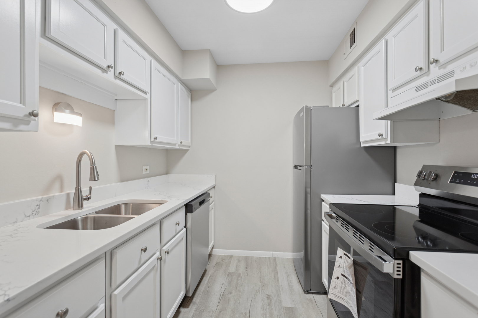 6185 Pinewood Court, Unit 202 Willowbrook, IL 60527 - Photo 2 of 20 a kitchen with stainless steel appliances granite countertop a sink stove and refrigerator