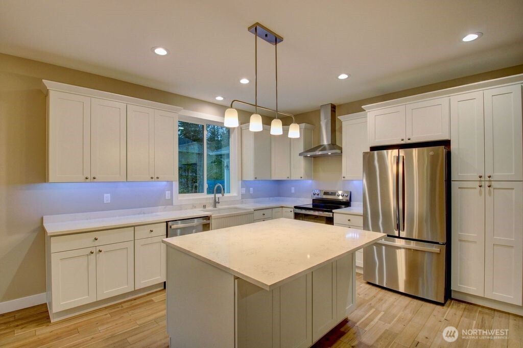 8583 Trillium Lane Concrete, WA 98237 - Photo 5 of 34 a kitchen with a refrigerator a sink and cabinets