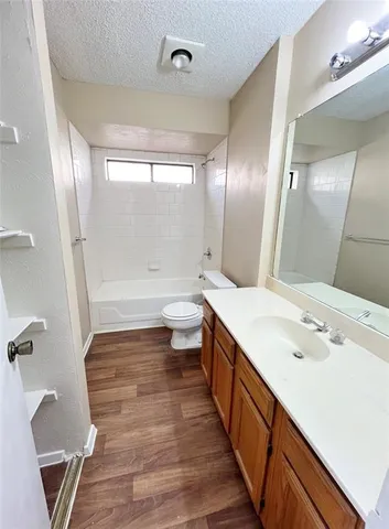 a bathroom with a double vanity sink toilet and shower