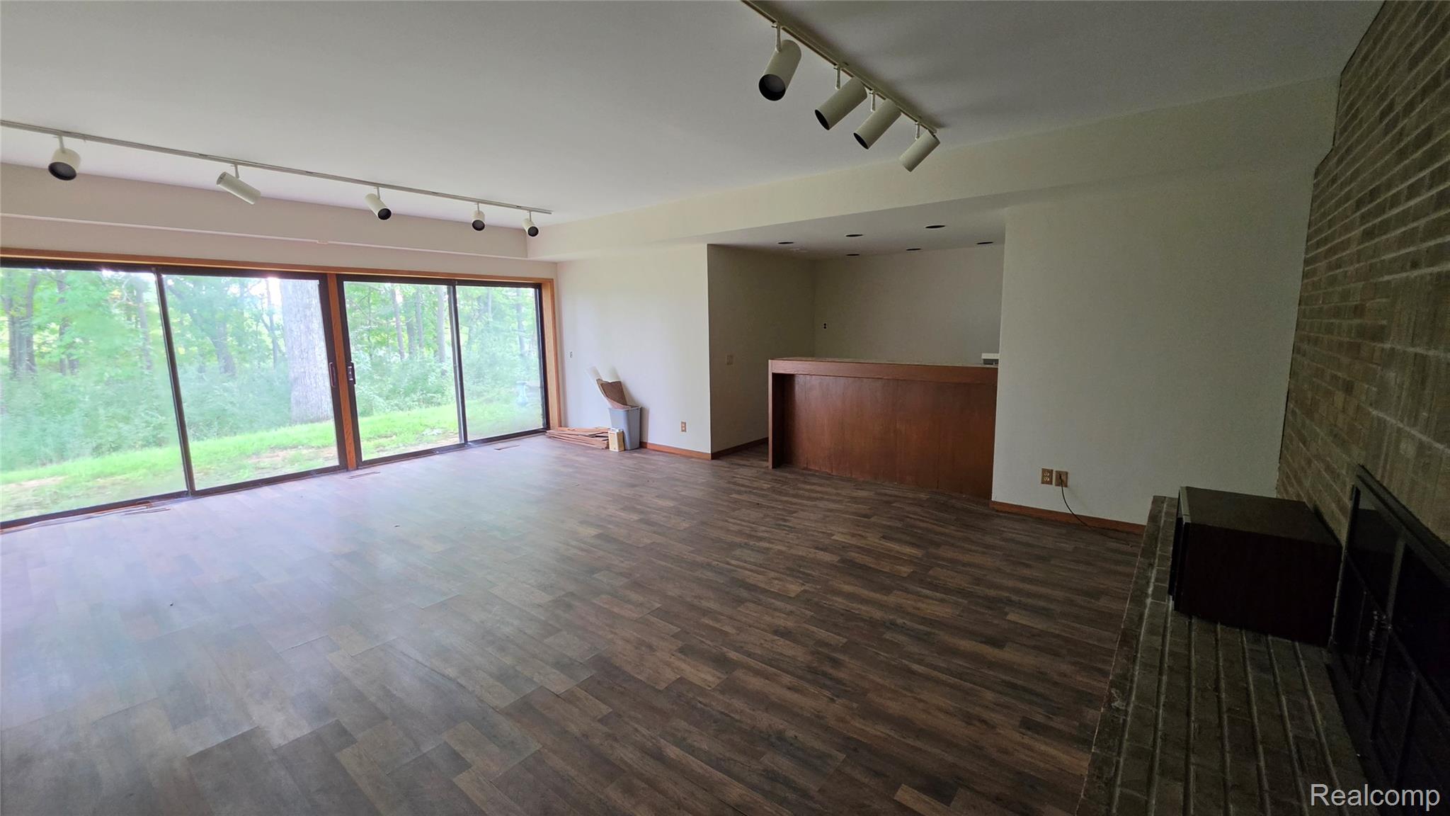 2551 Patterson Lk Road Pinckney, MI 48169 - Photo 22 of 37 Walkout Basement Family room with fireplace, wet bar and sliding glass doors to patio.
